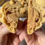 Decorating Easy Reese’s Peanut Butter NYC Cookies with peanut butter drizzle