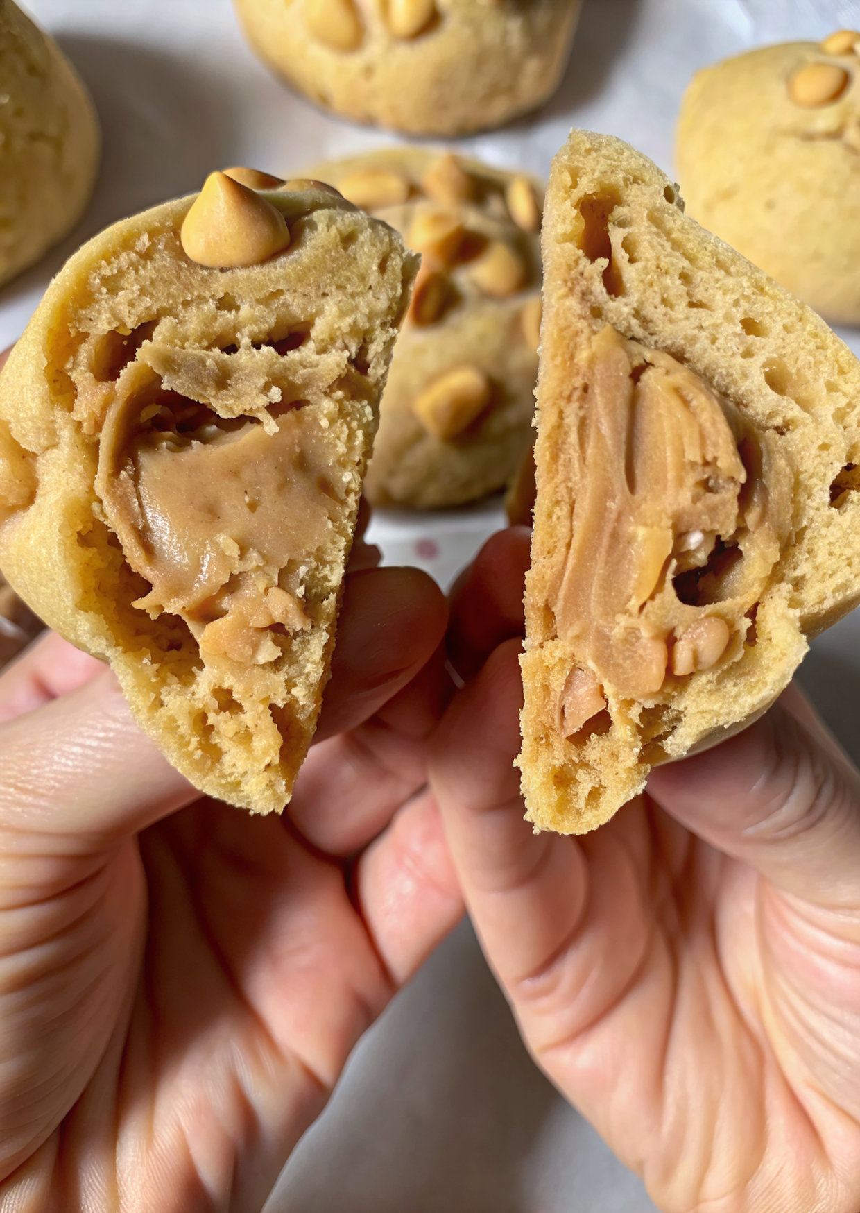 Decorating Easy Reese’s Peanut Butter NYC Cookies with peanut butter drizzle