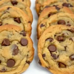 Brown butter chocolate chip cookies on a wooden table.
