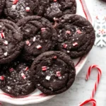 Delicious double chocolate peppermint cookies on a plate with crushed candy canes.