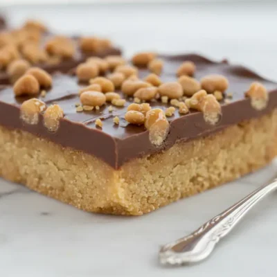Close-up of a single Butter Toffee Bar with chocolate and crunchy toffee topping.