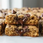 Close-up macro of Chocolate Chip Cookie Bars, showing soft, gooey interior with melted chocolate and golden-brown edges.