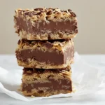 Close-up of a stacked trio of rich no bake chocolate oatmeal bars, showcasing their gooey center.